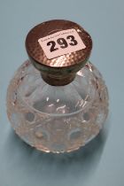 A silver top scent bottle