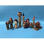 A wooden Russian doll and various Japanese wooden figures