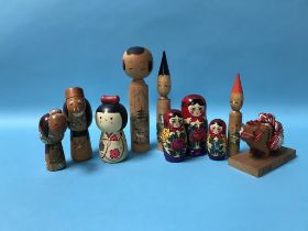 A wooden Russian doll and various Japanese wooden figures