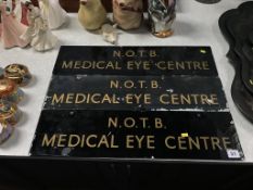 A set of three glass wall mounted signs, 'N.O.T.B. Medical Eye Centre', 61cm width