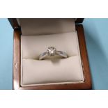 An 18ct white gold solitaire ring, 4.1g, size 'M', 0.8ct