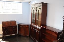 A reproduction bureau, bookcase, small cabinet and an open bookcase