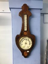 An Edwardian mahogany two glass inlaid barometer