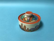 A Clarice Cliff Bizarre orange roof and blue tree design low cylindrical preserve pot