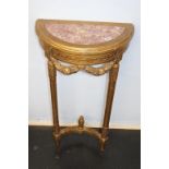 A half moon gilt wood and marble inset hall table