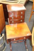 A reproduction mahogany chest of drawers and a small drop flap table