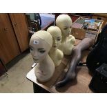 Three mannequin heads and a leg