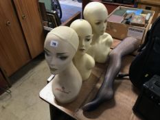 Three mannequin heads and a leg