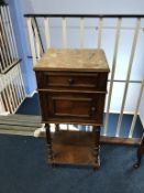 A walnut and marble top side cabinet