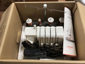 A boxed Bernina 800 DL over locker sewing machine