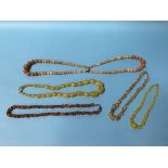 Various amber coloured necklaces