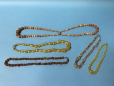 Various amber coloured necklaces