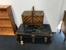 A blue travel trunk and a sewing box