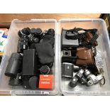 Two trays of various camera bodies, lenses and camera accessories