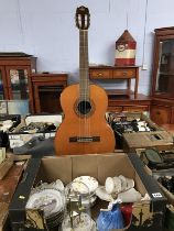 A box of china and an acoustic guitar