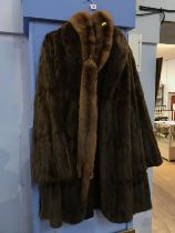 A horse harness mirror, a fur coat and a stole