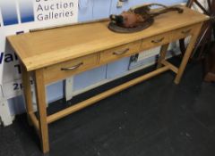 A light oak four drawer side table, 168cm wide