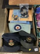 Two RAF military caps, a bag of assorted medals, cap badges etc.
