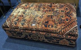 A Persian rug upholstered foot stool