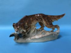 A Royal Dux model of a dog with a pheasant in it's mouth