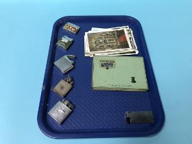 Collection of lighters, various and a cigarette box and old postcards