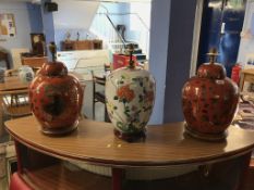 A pair of decorative table lamps and one other