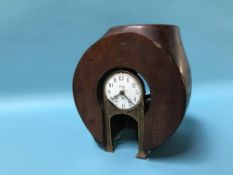 A wooden centre taken from a propeller shaft, inset with a Tiffany Never Wind Art Nouveau clock,