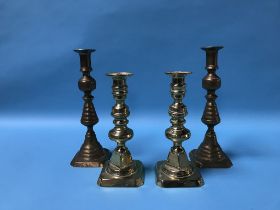 Two pairs of brass candlesticks
