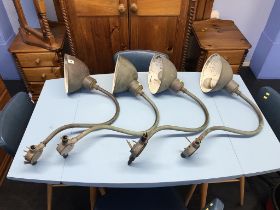 A set of four copper industrial wall mounted lights