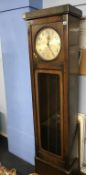 A 1930s oak longcase clock
