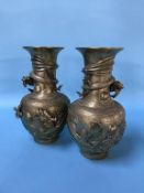 A pair of Oriental decorative metalwork vases