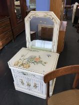 An oriental decorated cabinet with mirror