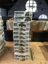 Twelve boxed Tamiya model kits