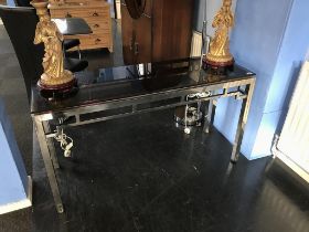 An oriental design chrome and glass top rectangular side table