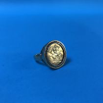 A 9ct ring, mounted with a half sovereign, 9g