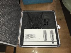 A boxed Perception 220 microphone