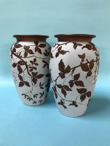 A pair of terracotta vase on a turquoise ground with incised floral decoration, H 29cm