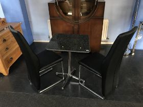 A granite top table and two chairs