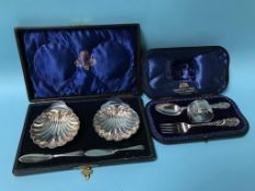 Cased silver christening set and a pair of cased silver butter dishes 184g