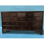 A mahogany bank of nineteen drawers, with turned brass handles, on bracket feet, 83 x 47 x 22cm