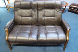 A brown leather two seater settee (as new)