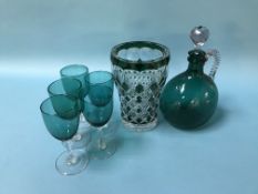 A green glass decanter, five glasses and a flashed green glass vase