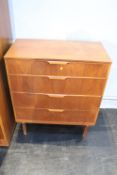 A teak chest of drawers, wardrobe and dressing table