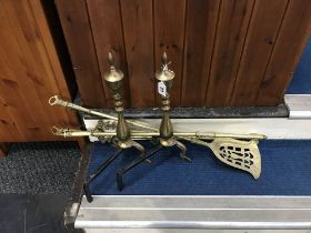 Brass fire irons and a pair of fire dogs