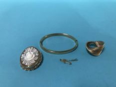A bangle and a brooch, stamped '375' and a cameo