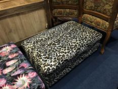 A leopard print footstool