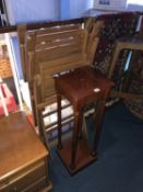 Two teak garden chairs and a pedestal