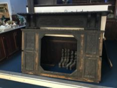 A large carved oak fire surround