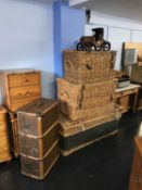A travel trunk, three large wicker baskets and a model car