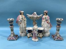 A German porcelain table centrepiece, a German figure of a lady, a pair of Staffordshire figures